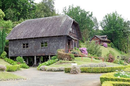 Watermill and traditional house in the garden at the German Museum a Frutillar, a town in Southern Chile in the Los Lagos Region on the banks of Lake Llanquihue. The German Colony thath arrived to the city in 1856 built their house, watermill, warehouse aのeditorial素材