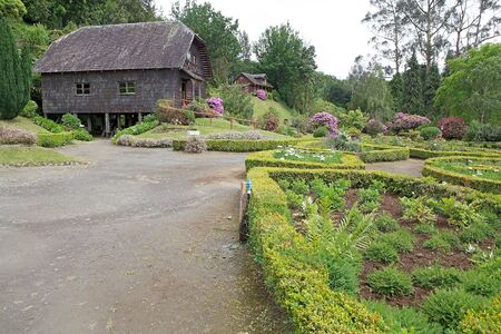 Watermill and traditional house in the garden at the German Museum a Frutillar, a town in Southern Chile in the Los Lagos Region on the banks of Lake Llanquihue. The German Colony thath arrived to the city in 1856 built their house, watermill, warehouse aのeditorial素材