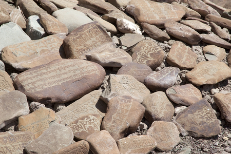 Mani stones at the Stok Palace in Ladakh, India. Mani stone, inscribed with a mantra,  is a form of prayer in Tibetan Buddhismのeditorial素材