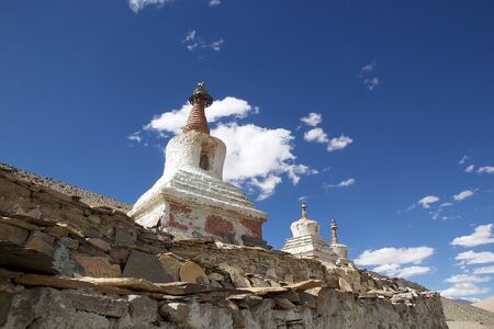 Stupas at the Karzok village on the shore of Tso Moriri Lake In Ladakh region in the Indian state of Jammu and Kashmir. The mountain lake is at an altitude of 4522 m in the Changthang Plateauの写真素材