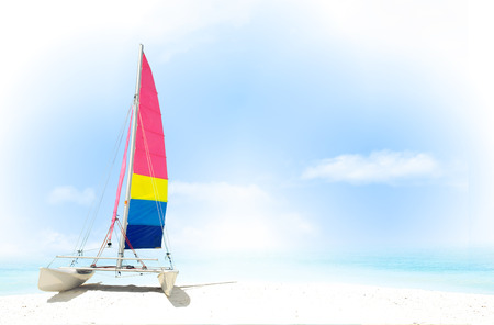 Catamaran on the white beach with sea and blue sky in the backgroundの写真素材
