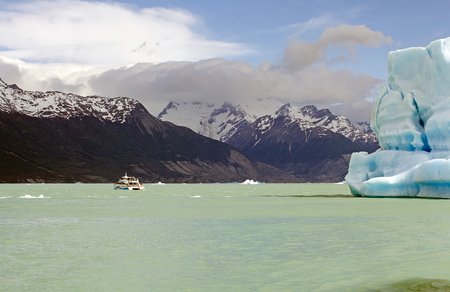 Tourist boat and iceberg in the Argentino Lake, Argentina. Argentino Lake is the biggest freshwater lake in Argentina.のeditorial素材