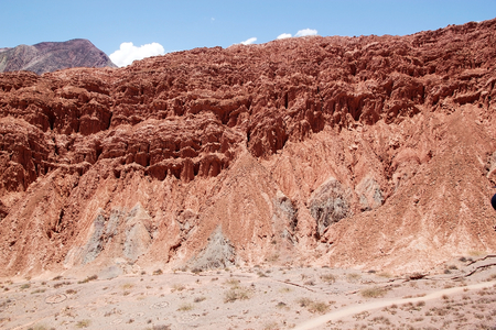 Tourists are walking along the road the Paseo los Colorados in the Quebrada de Purmamarca near...