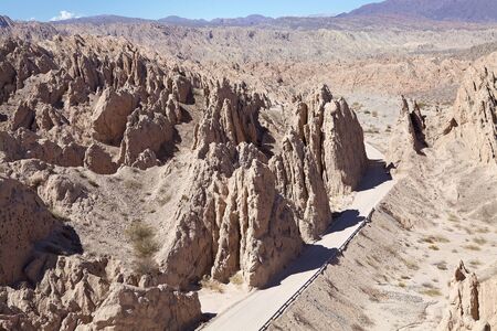 Road along the Gorge of Arrows rock formation just outside Angastaco, Argentina. Angastaco is a town...