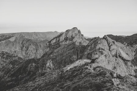 Madeira - A hiker group navigating a rugged mountain trail on Madeira, surrounded by dramatic rocky landscapes.の写真素材