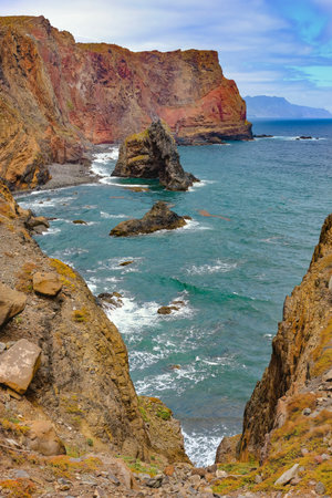 Rocky coastal cliffs with crashing waves against the shore, showcasing natural beauty and vibrant marine life in Ponta de SÃ£o LourenÃ§o, Madeira.の写真素材