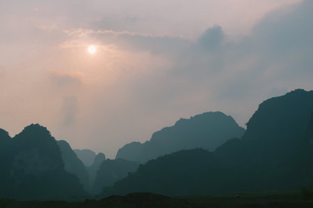 Misty sunrise over the mountains of Ninh Binh, Vietnam.の写真素材