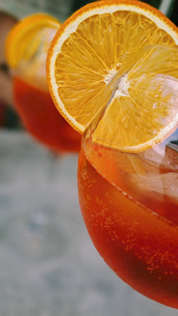 Close-up of an Aperol Spritz cocktail with an orange slice garnish in a glass.の写真素材