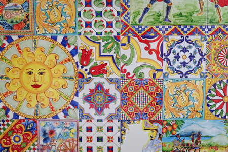 Colorful Sicilian ceramic tiles with traditional motifs including sun face, knights, fruits, floral...