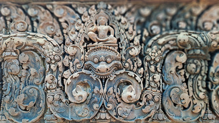 Intricately carved sandstone relief from Banteay Srei temple in Siem Reap province, Cambodia,...