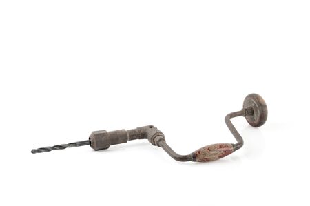 Old hand drill isolated on whiteの写真素材