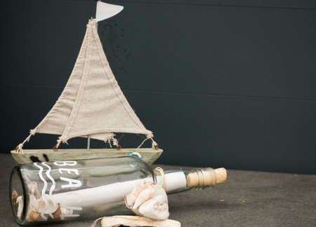 Message In A Bottle Glass Summer Paper Beach Vibe Shells Gray Backgroundの写真素材