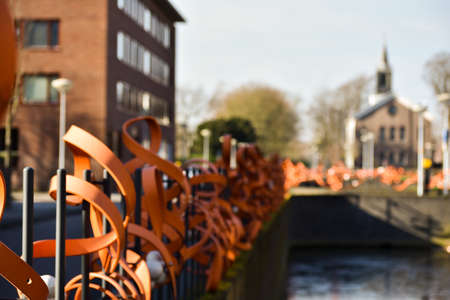 Pretty cool metal steel orange curly fence by the water side.の写真素材