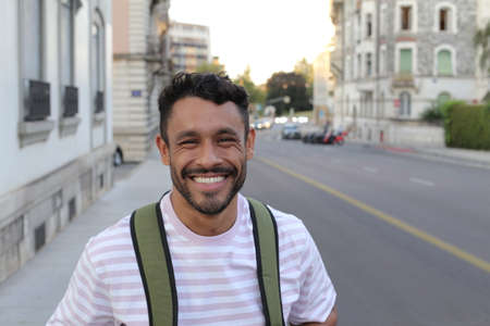 Handsome adult student with backpack outdoorsの写真素材