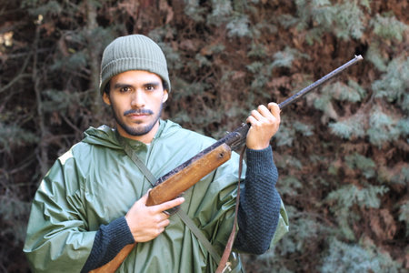 Ethnic hunter with camouflage green clothing