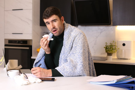 Man working from home with a coldの写真素材