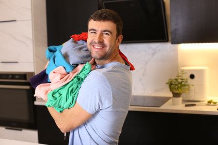 Cute man doing the laundryの写真素材