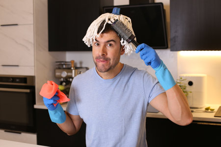 Funny man combing his mop hairの写真素材