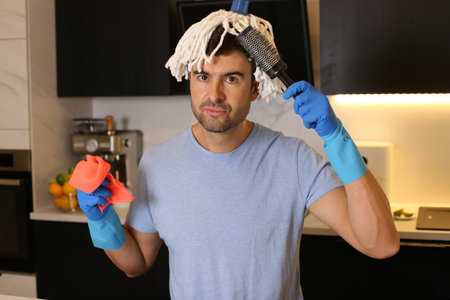 Funny man combing his mop hairの写真素材