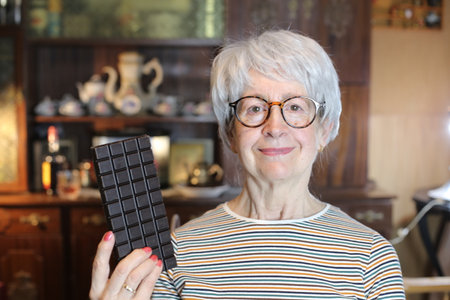 Senior woman holding some chocolateの写真素材