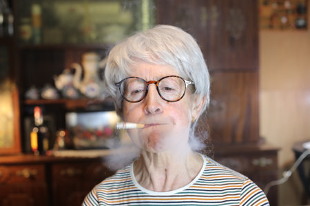 Senior woman smoking a cigaretteの写真素材