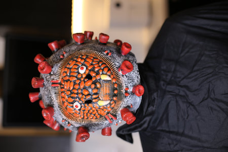 Close-up shot of a hand of a man wearing a maskの写真素材