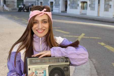 Gorgeous woman listening to music on the streetの写真素材