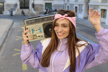 Gorgeous woman listening to music on the street