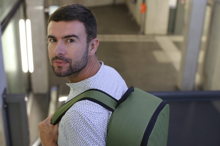Handsome entrepreneur walking with his elegant backpack