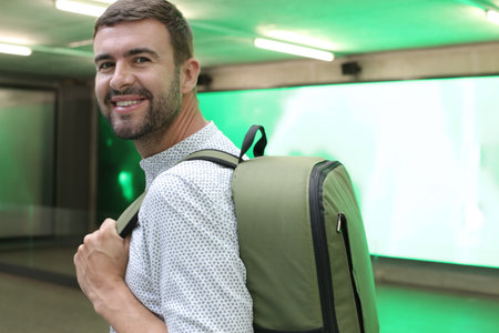 Handsome entrepreneur walking with his elegant backpack