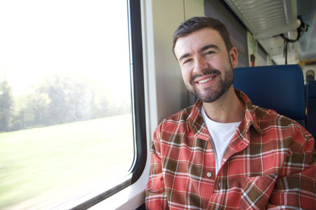 Handsome man sitting on train