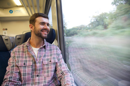 Handsome man sitting on trainの写真素材