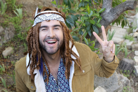 Hippie man showing peace hand gestureの写真素材