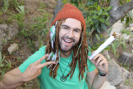 Hilarious man pretending to smoke an extra large jointの写真素材