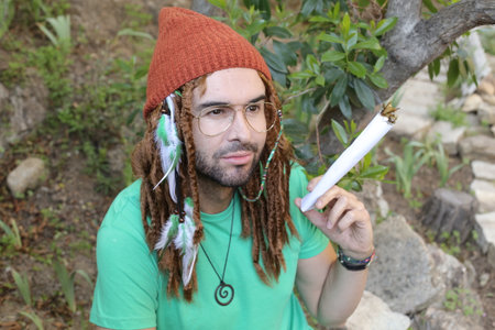 Man smoking something really natural in the forestの写真素材