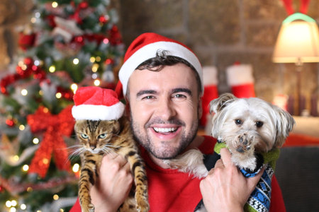 Man happy with his cute pets during Christmas timeの写真素材
