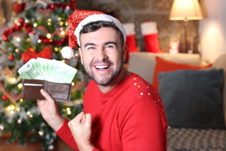 Man making tons of money during Christmas timeの写真素材