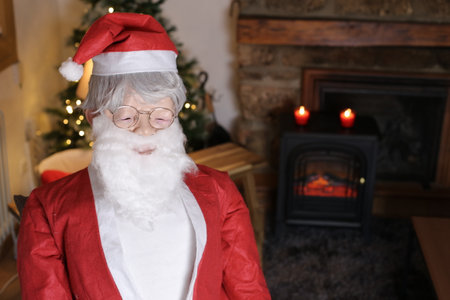 Santa Claus visiting another home for Christmasの写真素材