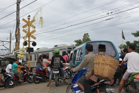 Jakarta, Indonesia, 3 March 2012 - Queues of vehicles at railroad crossings in the suburbs of...