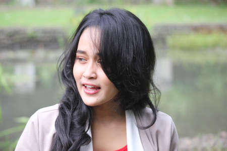 A beautiful women smiling in a gardenの写真素材