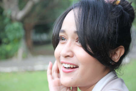 A beautiful women smiling in a gardenの写真素材