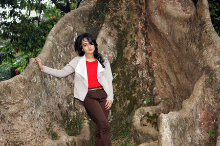 A beautiful women under big tree in a gardenの写真素材