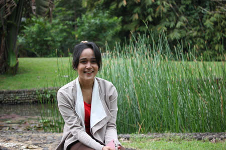 A beautiful girl smiling in a gardenの写真素材