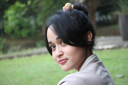 A beautiful girl smiling in a gardenの写真素材