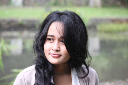 A beautiful girl smiling in a gardenの写真素材