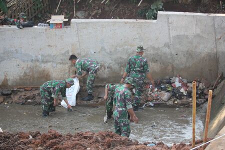Depok, Indonesia, 13 September 2014 - Indonesian National Army to clean up the river.のeditorial素材