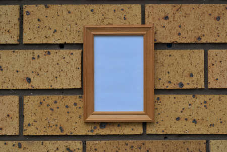Empty frame on brick wallの写真素材