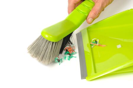 Red brush and dustpan with some garbage on white background