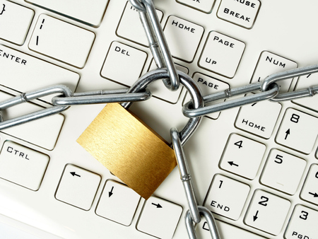 Computer keyboard locked with padlock and chain