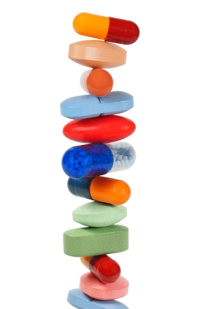 High stack of pills isolated on white background High stack of pills isolated on white background